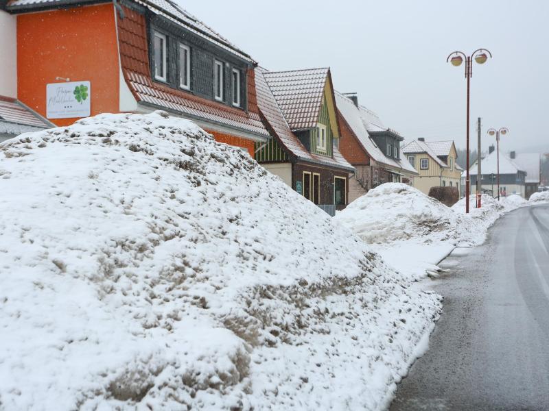 Schneeberge türmen sich vor Wohnhäusern in Schierke (Sachsen-Anhalt) im Oberharz. Foto: Matthias Bein/dpa-Zentralbild/dpa