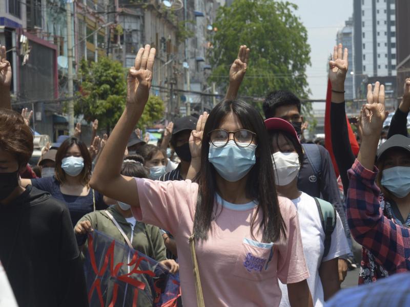 Anti-Putsch-Demonstranten zeigen während eines Protests in Rangun gegen die Militärregierung den Drei-Finger-Gruß als Zeichen des Protests. Foto: Uncredited/AP/dpa