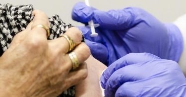 Die Einstichstelle am Arm einer Frau in Kiel wird nach dem Impfen desinfiziert. Foto: Frank Molter/dpa