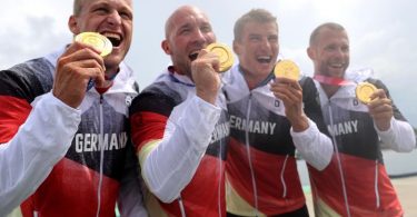 Max Rendschmidt, Ronald Rauhe, Tom Liebscher und Max Lemke feiern mit ihren Goldmedaillen. Foto: Jan Woitas/dpa