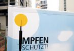 «Impfen schützt»: Ein Hinweisschild für ein Impfzentrum in Stuttgart. Foto: Bernd Weißbrod/dpa