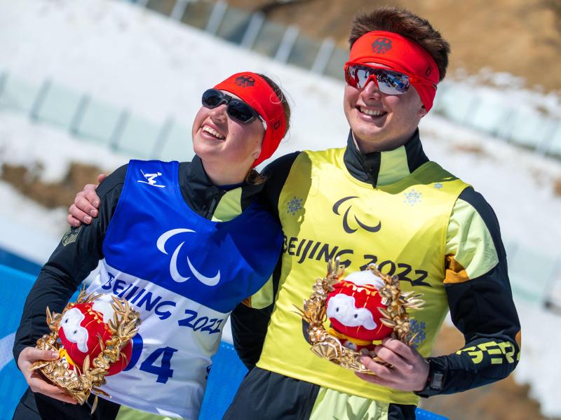 Die 18-jährige Leonie Walter und ihr Guide Pirmin Strecker feiern nach dem Rennen über 15 Kilometer ihre Bronzemedaille. Foto: Jens Büttner/dpa-Zentralbild/dpa