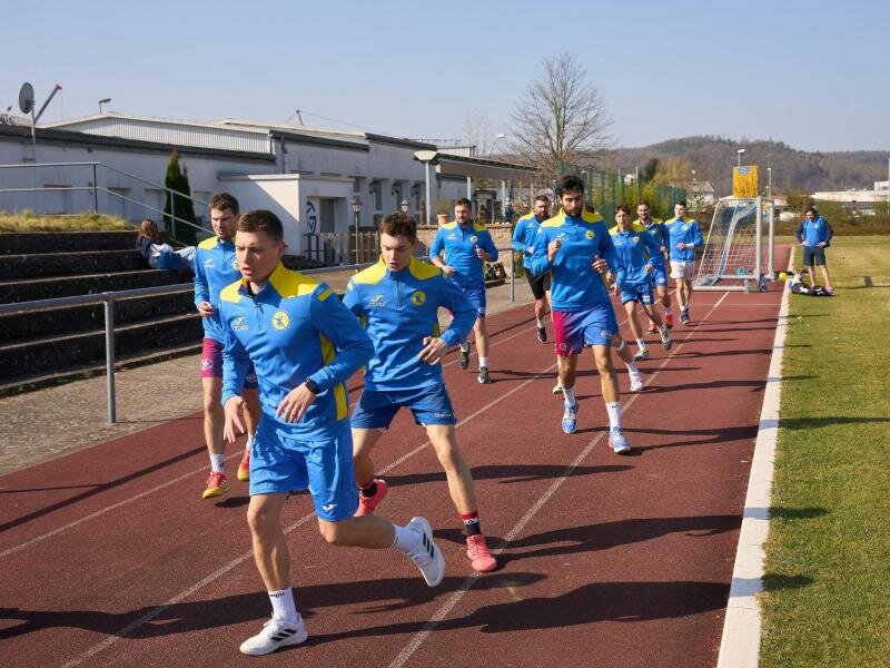 Das Handball-Nationalteam der Ukraine trainiert auf einem Sportplatz in Großwallstadt. Foto: Thomas Frey/dpa