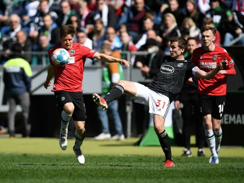Hannovers Dominik Kaiser (l) und Düsseldorfs Marcel Sobottka trennten sich ohne Tore 0:0. Foto: Daniel Reinhardt/dpa