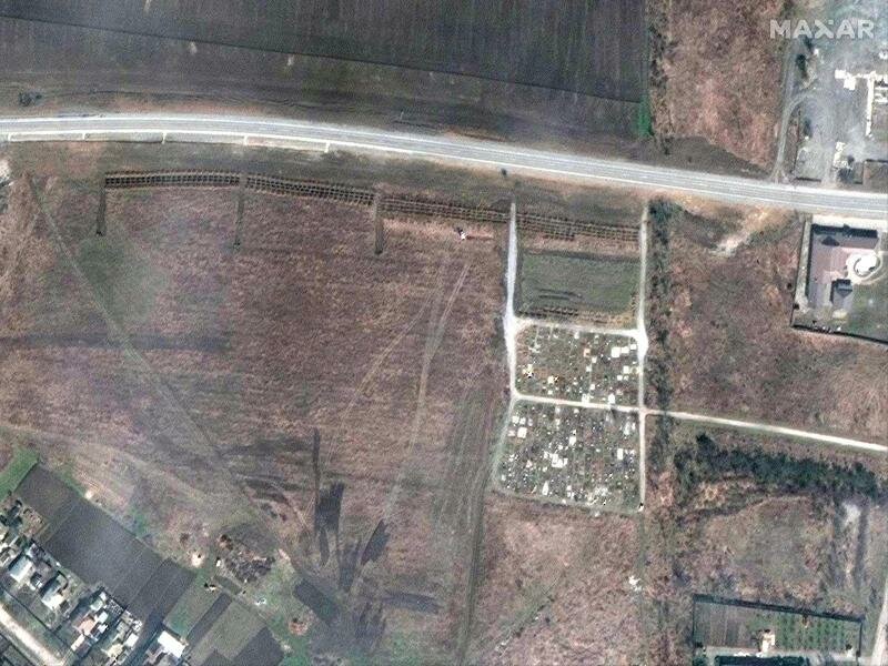 Dieses von Maxar Technologies zur Verfügung gestellte Satellitenfoto soll ein Massengrab in Manhusch in der Nähe eines Friedhofs parallel zum Straßenverlauf zeigen. Manhusch liegt ca. 20 km westlich von Mariupol. Foto: ---/“Satellite image ©2022 Maxar Technologies/dpa