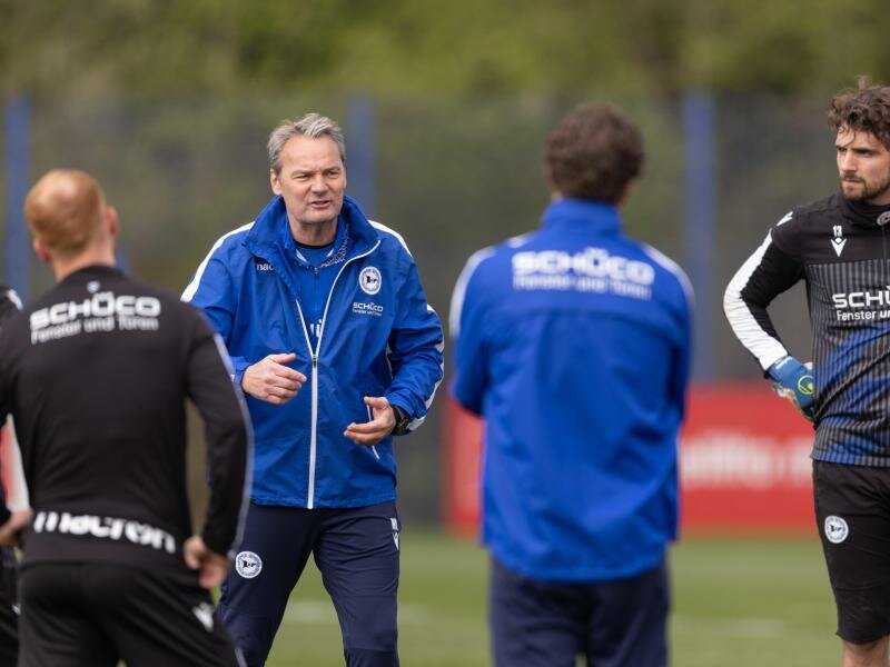 Der bisherige Torwarttrainer Marco Kostmann (2.v.l) spricht als Hauptverantwortlicher beim Training von Arminia Bielefeld. Foto: Friso Gentsch/dpa