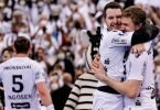 Magnus Landin (r) und Miha Zarabec feiern den Pokal-Sieg des THW Kiel. Foto: Axel Heimken/dpa