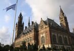 Die Flagge der Vereinten Nationen weht im Wind vor dem Internationalen Gerichtshof in Den Haag. Foto: Mike Corder/AP/dpa