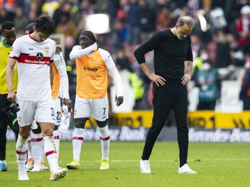 VfB-Trainer Pellegrino Matarazzo (r) und seine Spieler lassen nach dem 1:1 gegen Wolfsburg die Köpfe hängen. Foto: Tom Weller/dpa
