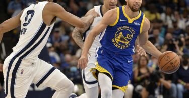Golden States Stephen Curry (r, 30) in&nbsp;Aktion neben Brandon Clarke (M) von Memphis. Foto: Brandon Dill/AP/dpa