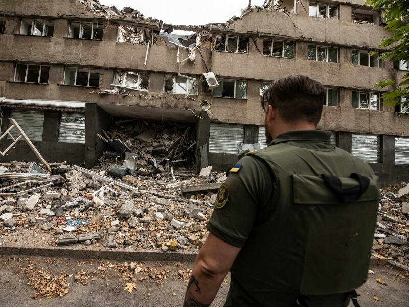 Ein ukrainischer Soldat steht vor einem zerstörten Haus in Mykolajiw. Es ist eine der am meisten angegriffenen Städte des Landes. Foto: Hector Adolfo Quintanar Perez/ZUMA Press Wire/dpa