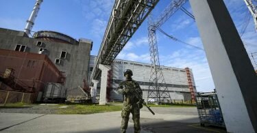 Ein russischer Soldat bewacht einen Bereich des Kernkraftwerks Saporischschja. Das Foto wurde während einer vom russischen Verteidigungsministerium organisierten Reise aufgenommenen. Foto: -/AP/dpa