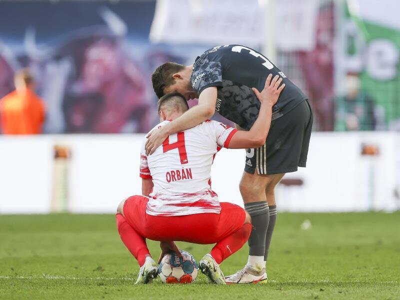 Ein Spieler von Union Berlin tröstet nach dem Sieg der Eisernen RB Leipzigs Willi Orban. Foto: Jan Woitas/dpa